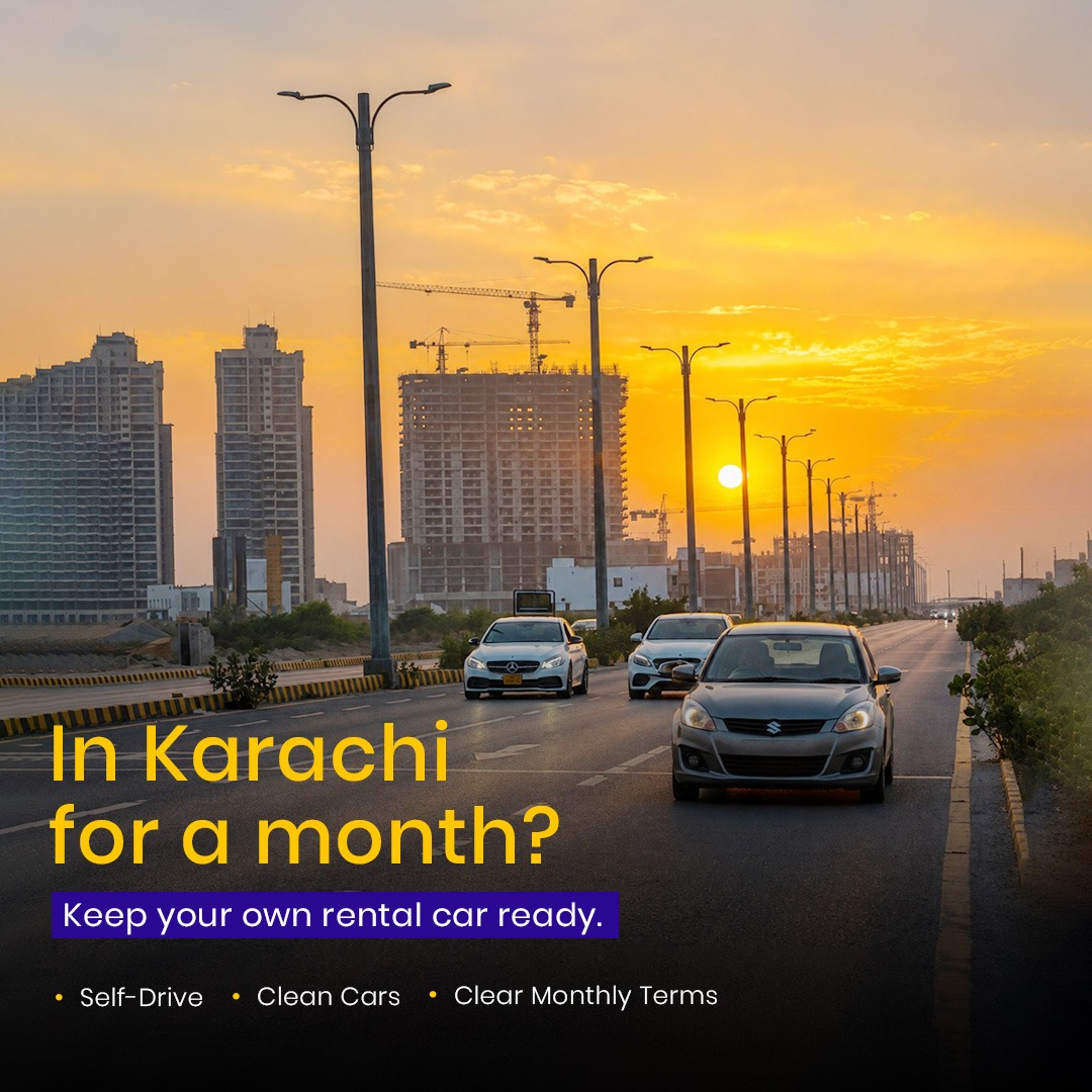 Rental cars driving through Karachi at sunset